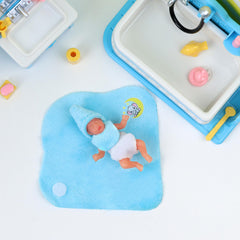 BABESIDE baby swaddles blue foreground emphasizes cozy secure handling during pretend care.