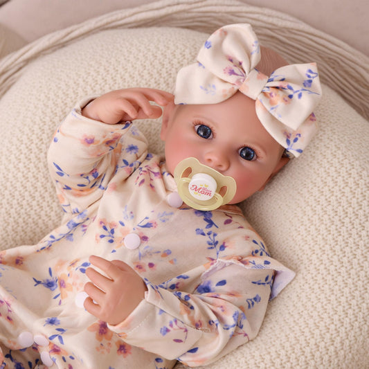 BABESIDE reborn baby doll face closeup showing lifelike eyelashes for imaginative play.