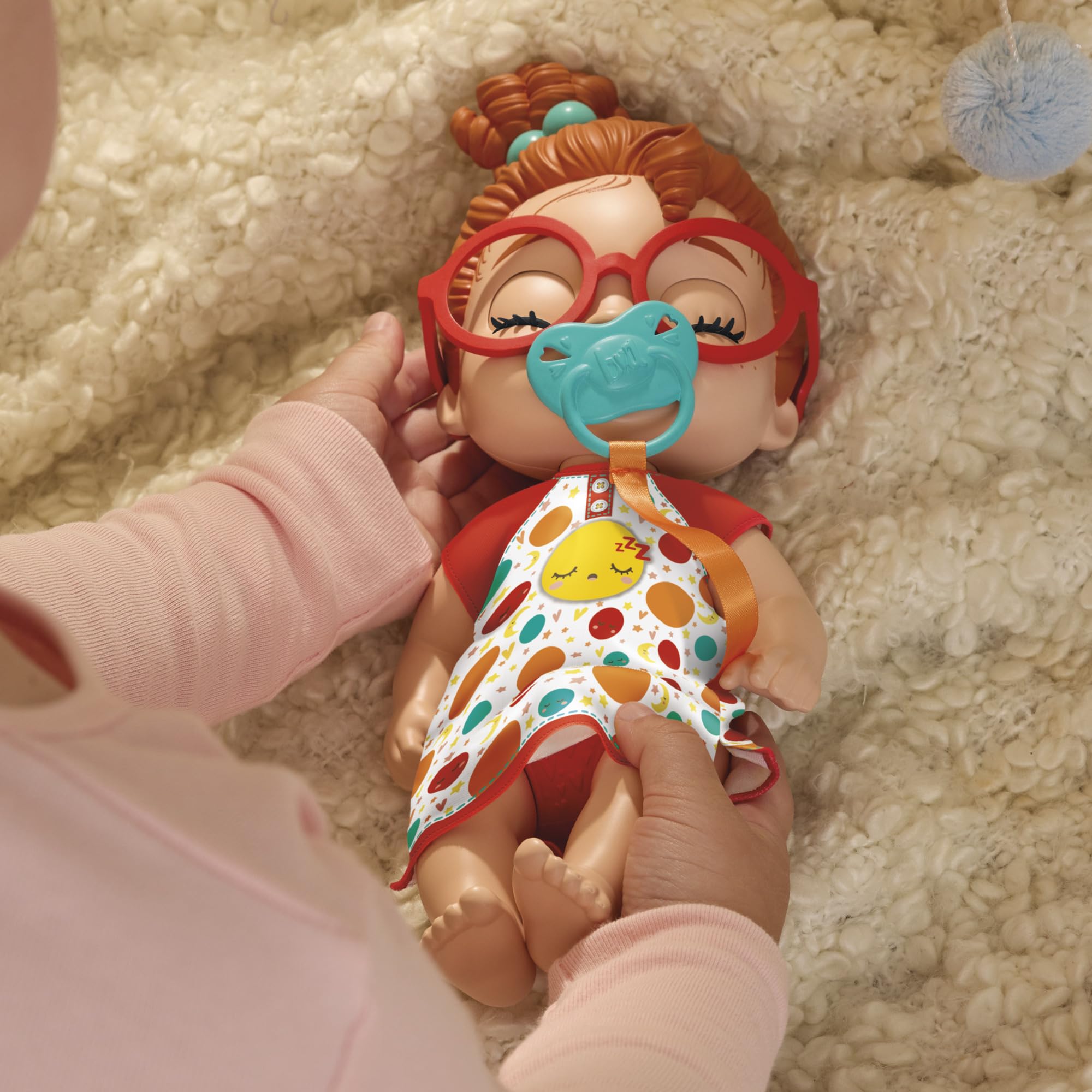 Dottie Doodle eyes open and close with tethered pacifier during interactive play
