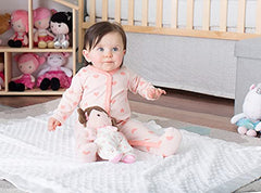 Close-up of Baby Starters Olivia plush doll showing rattle feature for baby entertainment