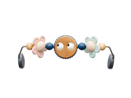 BabyBjörn Googly Eyes Pastels toy bar spins to engage baby during playtime.