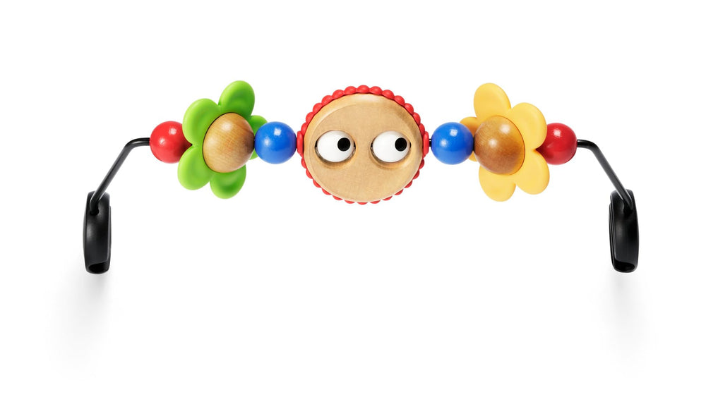 BabyBjörn wooden toy with googly eyes attaches securely to the bouncer for visual stimulation.