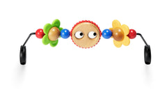 BabyBjörn wooden toy with googly eyes attaches securely to the bouncer for visual stimulation.