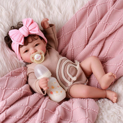 BABESIDE Mia poseable cloth body supports natural sitting and snuggling.