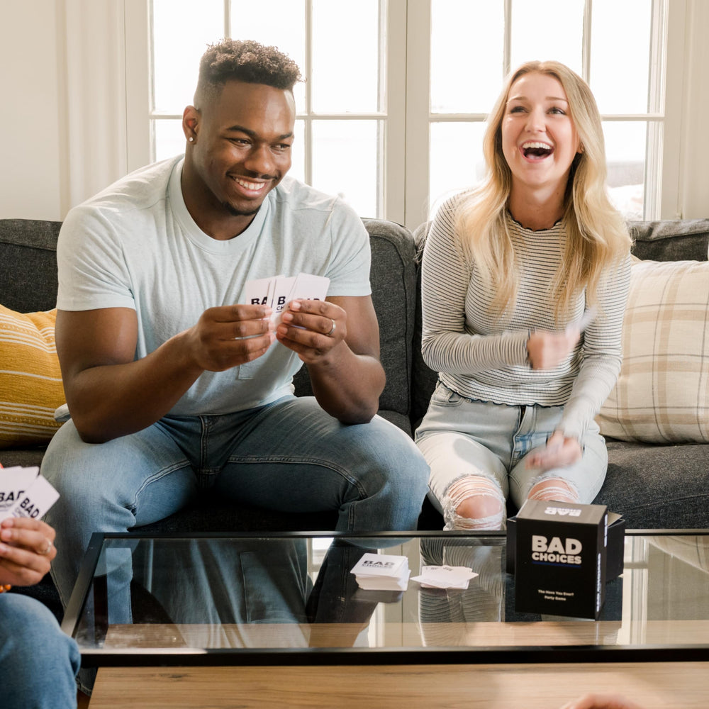 Bad Choices players laugh together during a round, perfect icebreaker