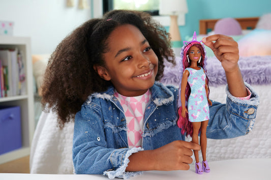 Barbie Fun & Fancy Hair doll wearing a glossy pink minidress and accessories