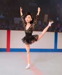 Gold ribbon hair detail on Kristi Yamaguchi Barbie adds authentic charm.