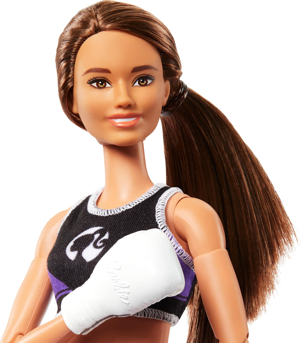 Barbie Made to Move boxer doll wearing boxing gloves supports imaginative sports battles.
