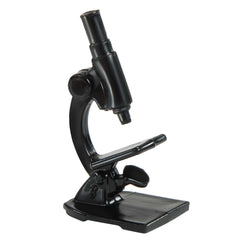 Barbie doll in flats uses a microscope for imaginative research play.