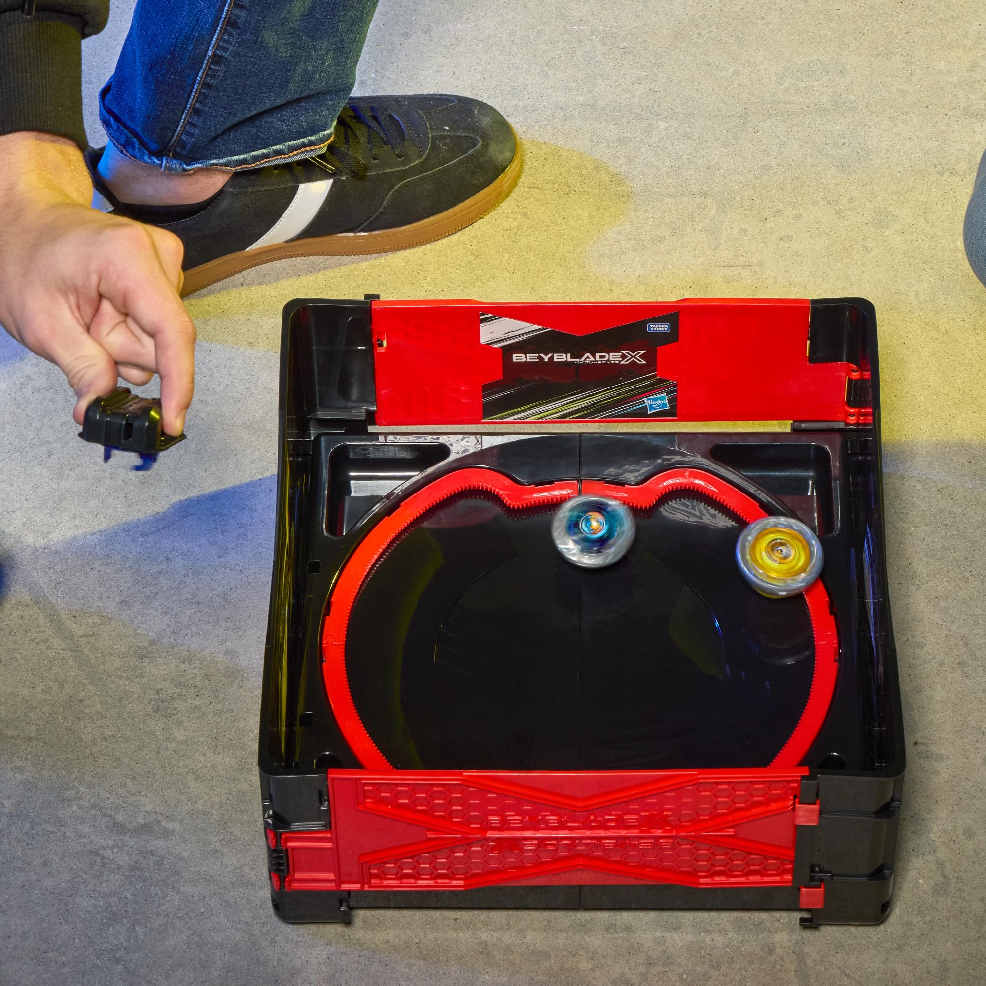 Beyblade stadium held in hand showing portable size and convenience