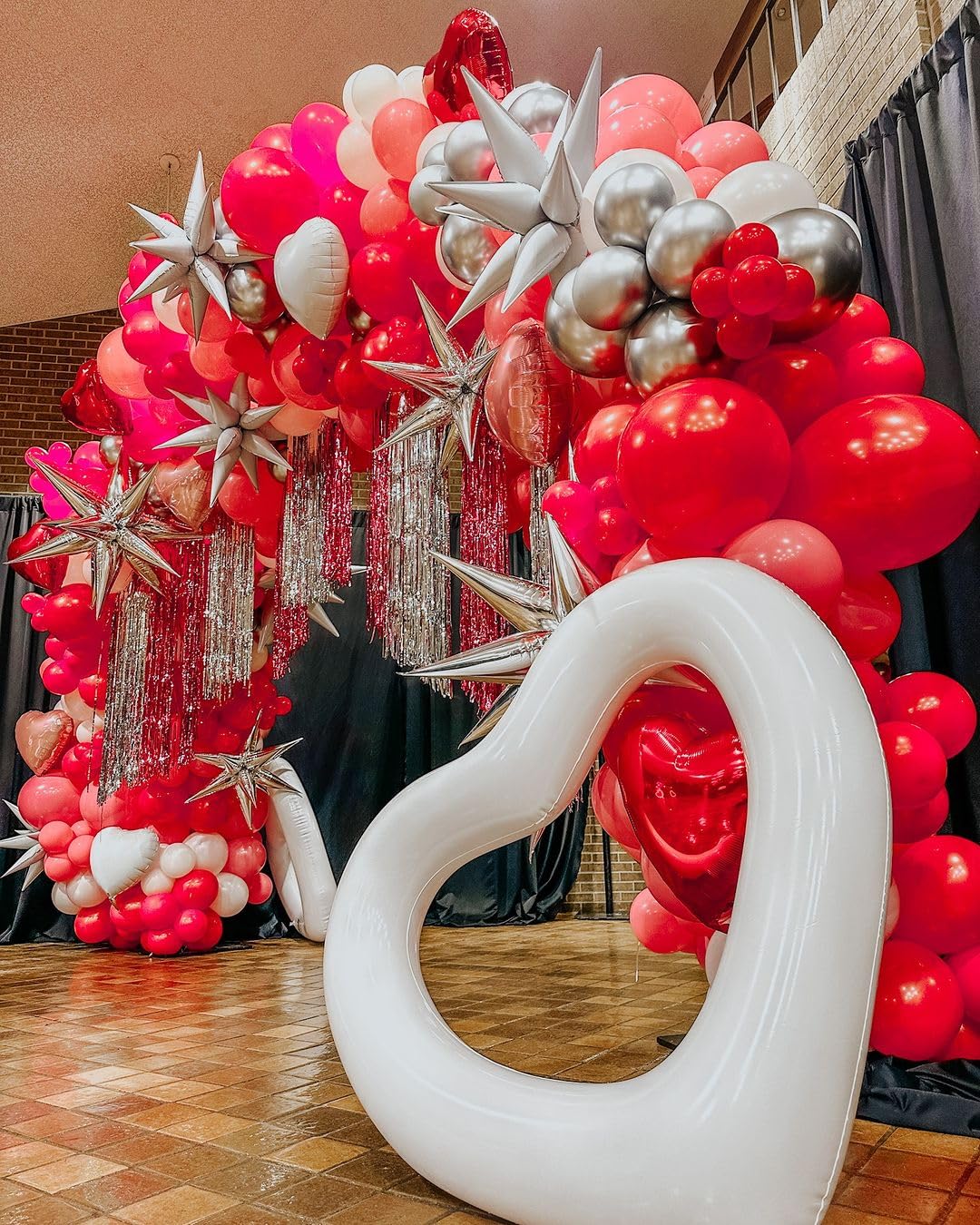 Bezente red balloons as a wedding decor statement.
