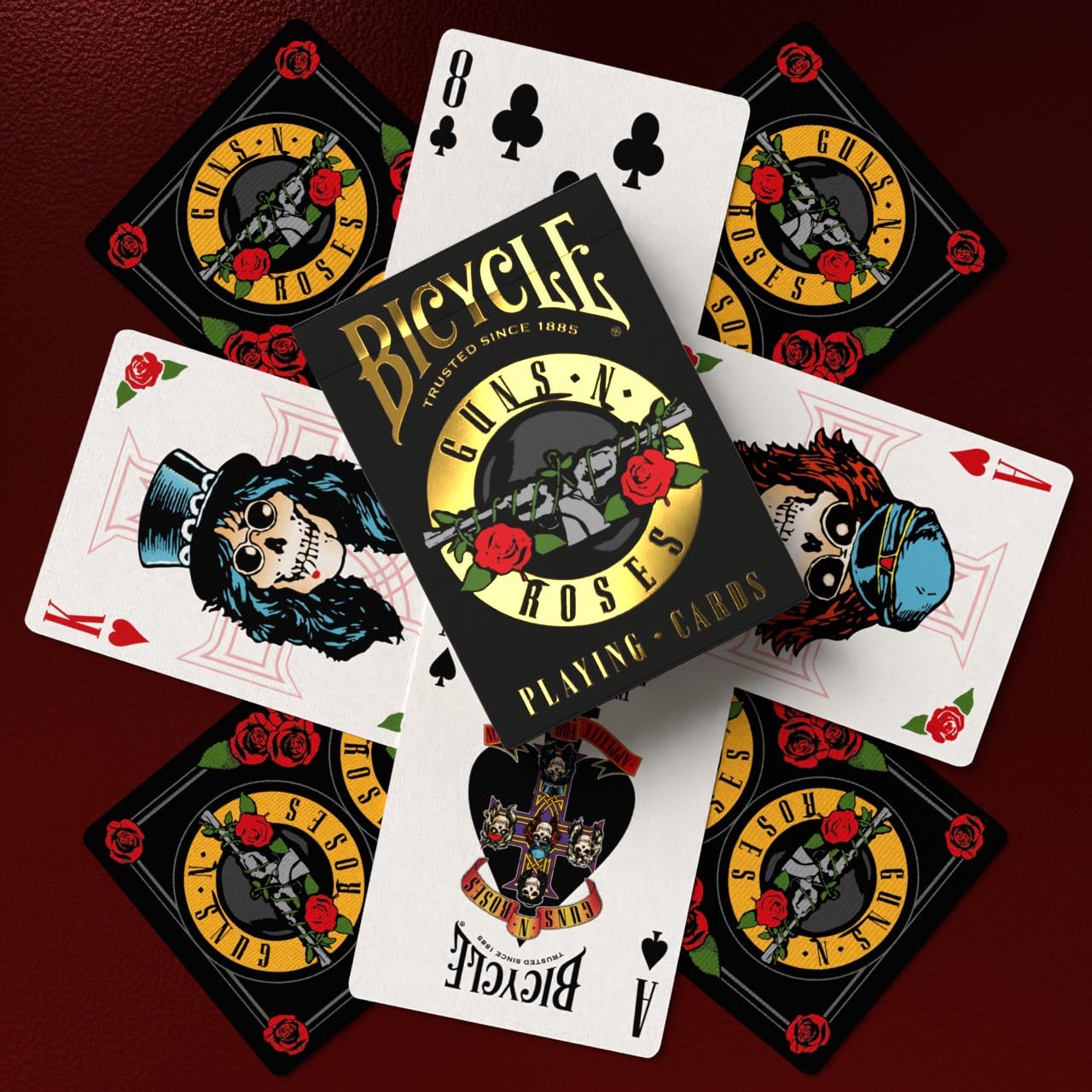 Friends playing cards with Bicycle Guns N' Roses deck adding rock-themed atmosphere