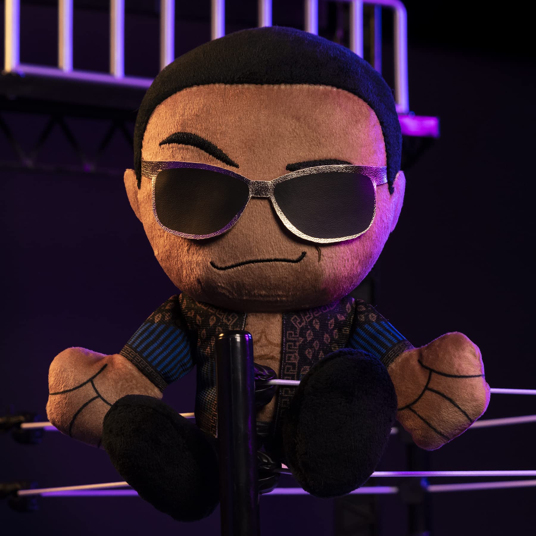 Bleacher Creatures WWE Old School Rock Kuricha plush on a shelf-ready display stand.