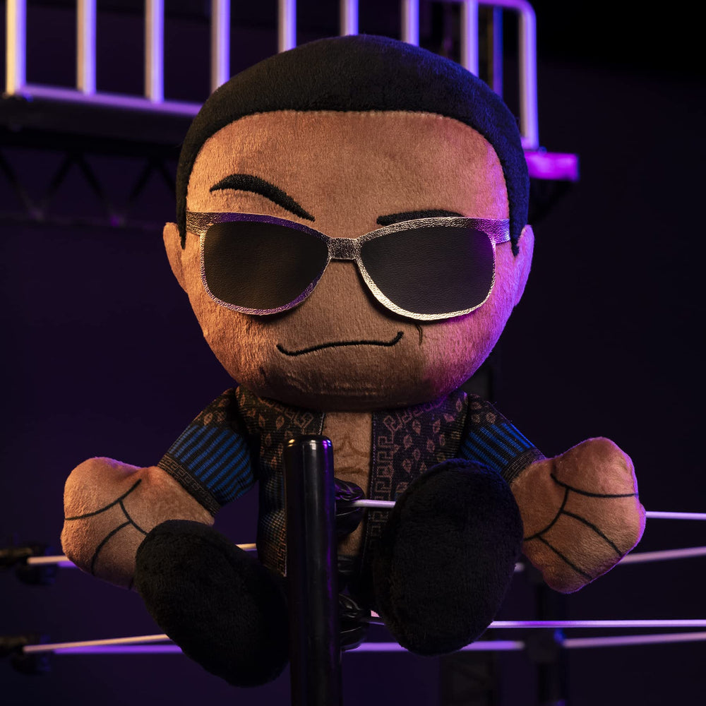 Bleacher Creatures WWE Old School Rock Kuricha plush on a shelf-ready display stand.