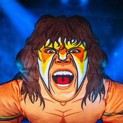 Bleacher Creatures WWE Ultimate Warrior 24-inch Bleacher Buddy, lifestyle shot, on display shelf.