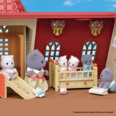 Calico Critters Persian Cat Sister Skye studying weather instruments for science play.