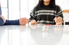 CATAN Dice Game scene with family illustrating approachable setup for kids.