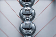 CERROPI Newton cradle chrome bar emphasizes durability for long, smooth swings.
