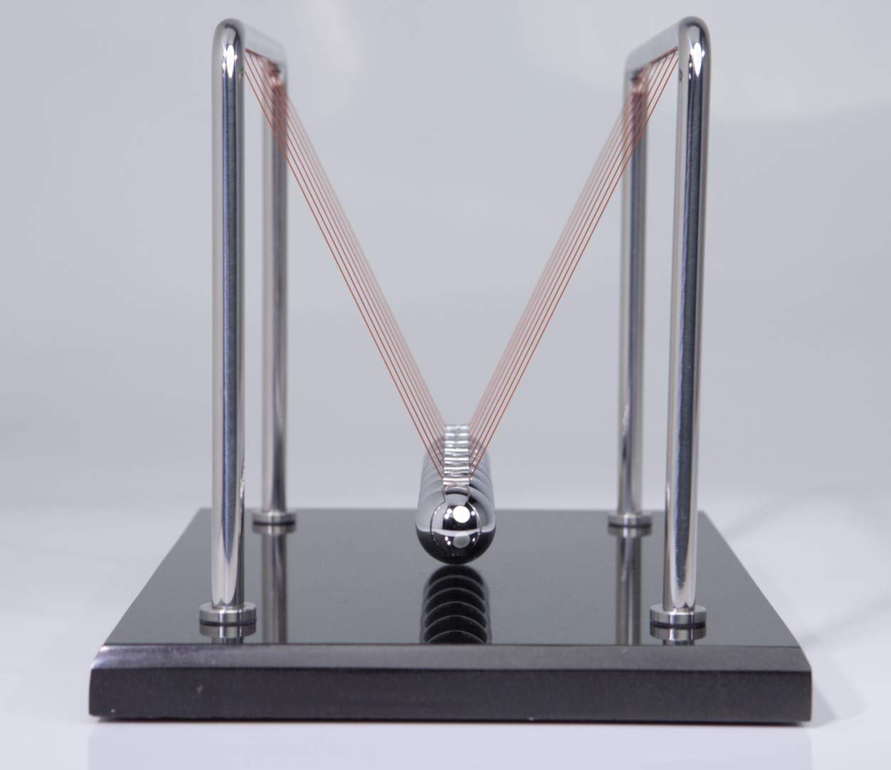 CERROPI Newton cradle in action illustrates energy transfer and play potential.