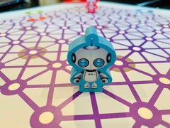 CoderMindz AI Learner Game robot figure aiding hands-on exploration.