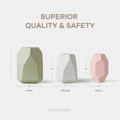 Child stacking Comfy Cubs wooden rocks to develop hand-eye coordination during play