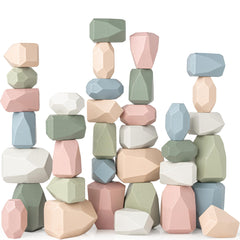 Comfy Cubs wooden stacking rocks being stacked to boost fine motor skills and imagination