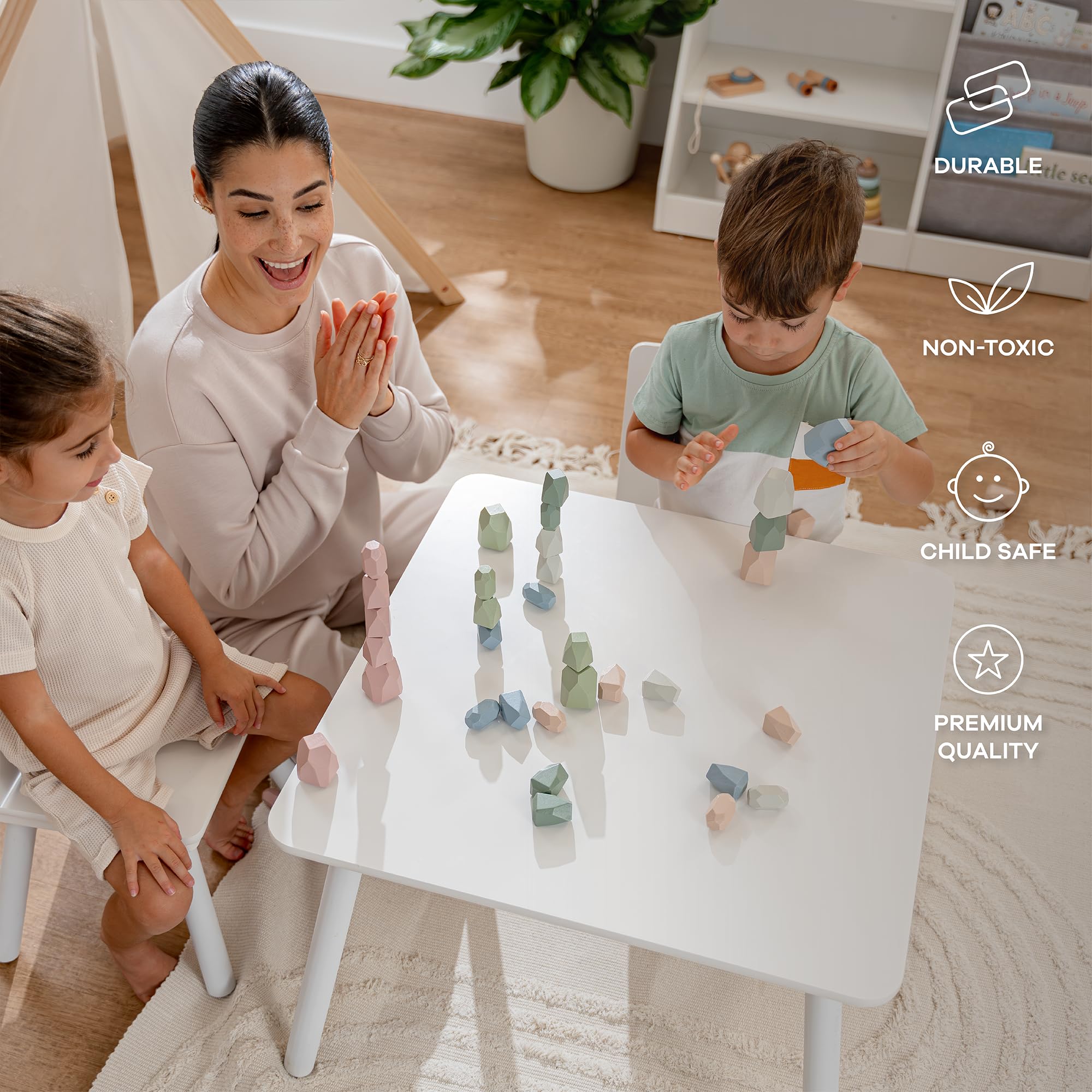 A toddler practicing stacking with Comfy Cubs rocks in a beginner play setup