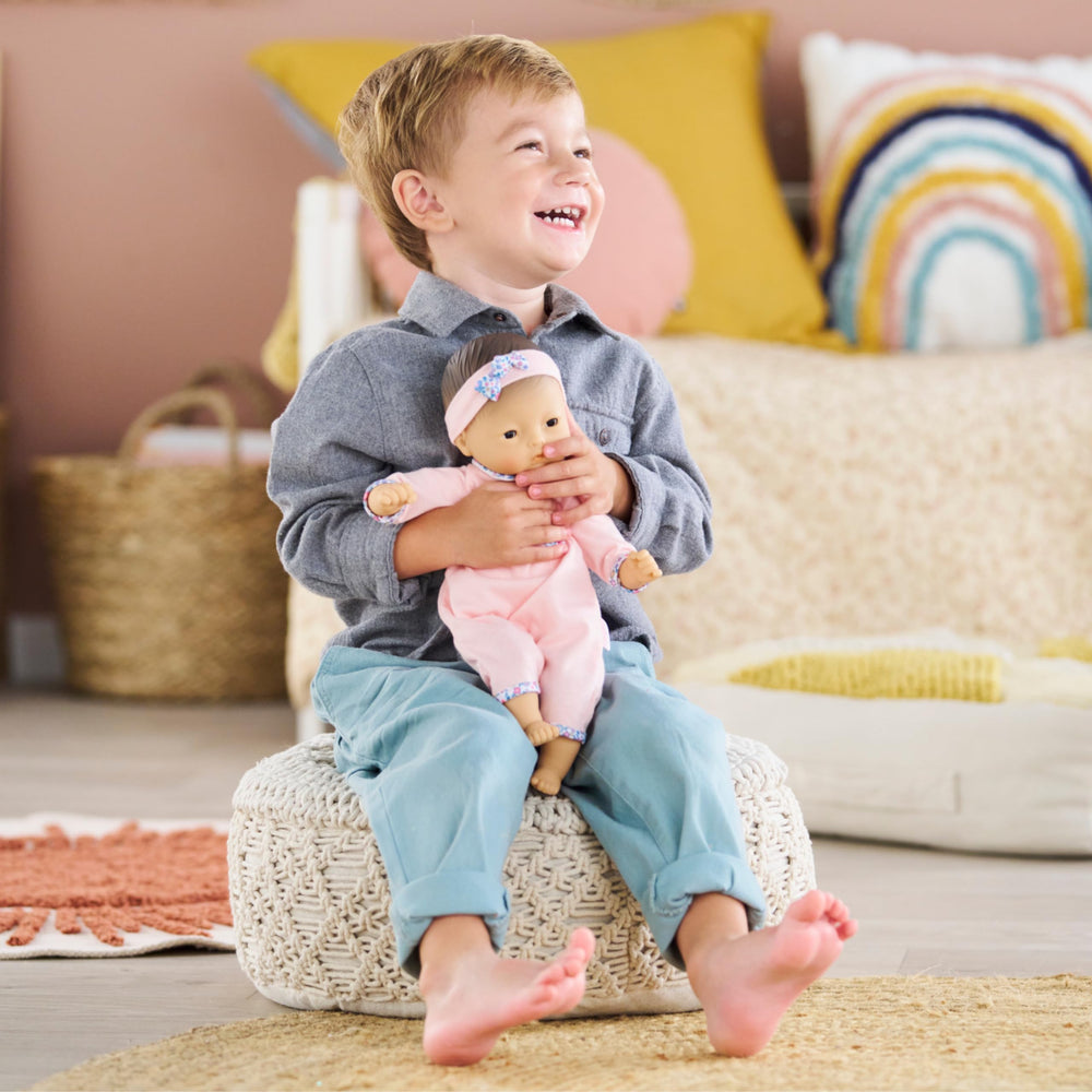 Corolle Bebe Calin Mila's bean-filled body allows lifelike posing and cuddling.