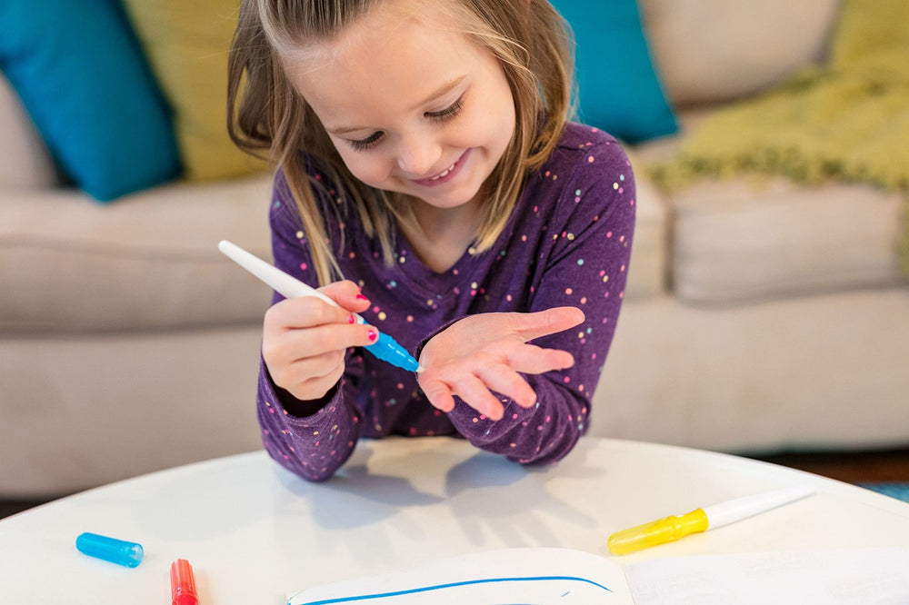 Crayola Color Wonder paints in Red, Orange, Green, Yellow, and Blue for vibrant lines