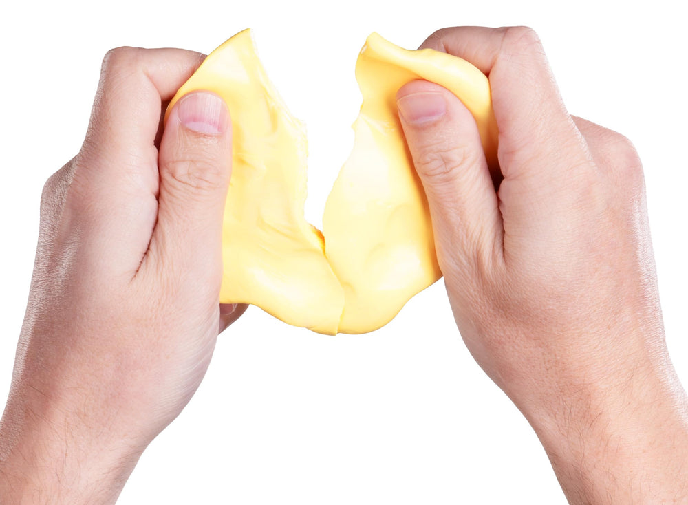 Crazy Aaron's Better Butter Thinking Putty on workspace, a non-toxic fidget option for concentration.
