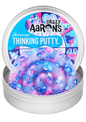 Crazy Aaron's Horoscope Thinking Putty tin with charms for tactile fun.