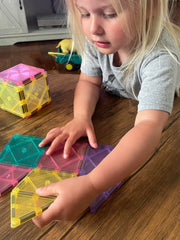 CreateOn Crayola magnetic tiles pastel child playing with color patterns and shapes.