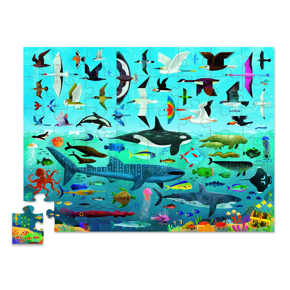 Two kids playing Crocodile Creek Above + Below puzzle on the floor