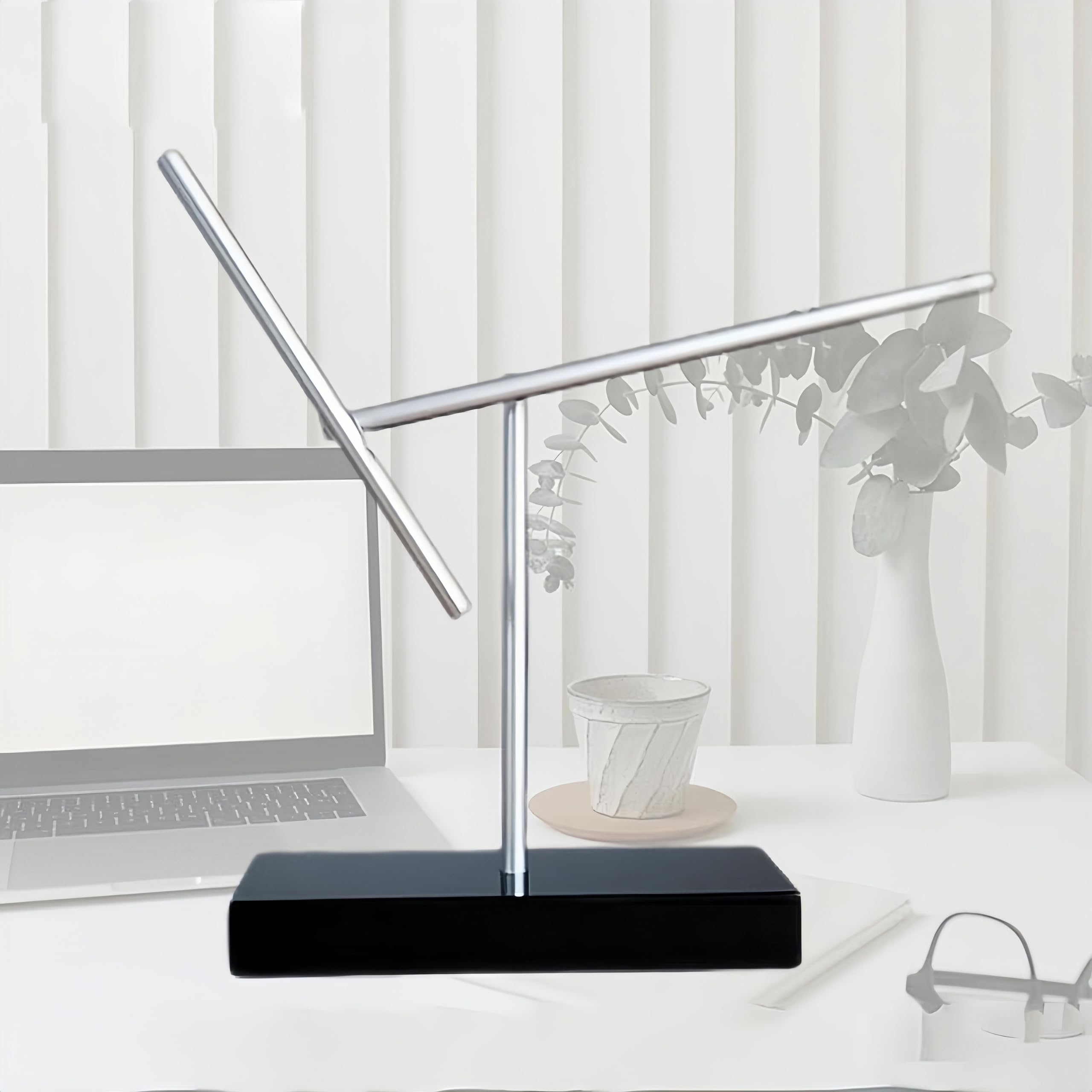 CulinaryEdge kinetic energy sculpture double-pendulum detail enhances modern office ambiance