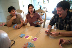 Dad Bomb Games Triples tabletop night scene encourages group play.