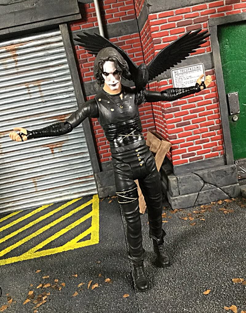 Diamond Select Toys The Crow Walgreens Exclusive accessories with the figure, including gravestone and guitar for display.