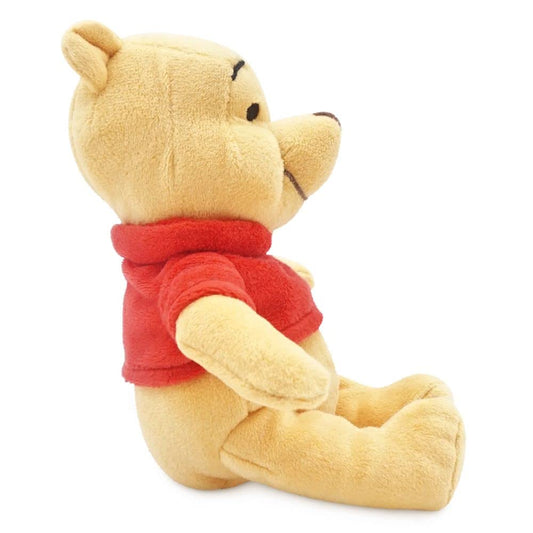 Pooh plush with red sweater detail highlights craftsmanship and collectability for Disney fans.