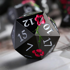 DNDND flower metal dice D10 in matte black with pink flower, smooth throws.