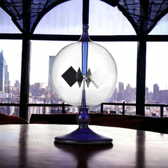 DORAMI blue glass radiometer close-up showing delicate vanes and glow.