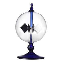 DORAMI blue solar power radiometer glass vane spins in sunlight, a kinetic desk sculpture.