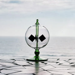 DORAMI Crystal-clear glass radiometer close-up emphasizes delicate, handmade detail.