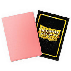 Dragon Shield Peach sleeves in hand highlighting easy shuffle and durable design.