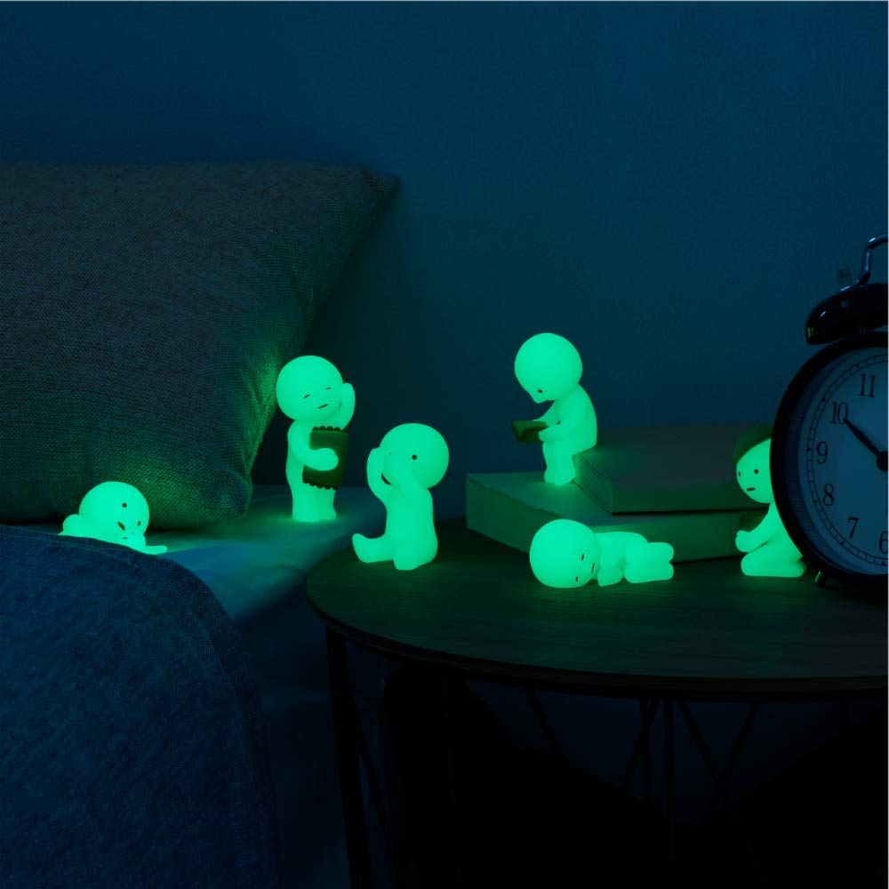 Dreams Smiski glow-in-the-dark figurine provides a gentle glow for late reading