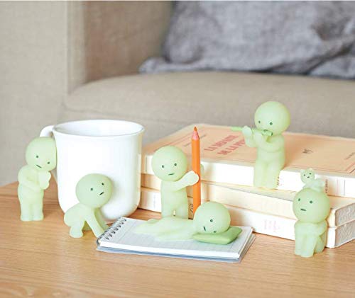 Dreams Smiski phosphorescent figure glowing softly in low light for ambiance
