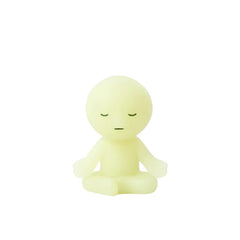 Dreams Smiski Zipperbite Volume 2 in Lotus Pose attached to a bag, offering a subtle, calming glow.