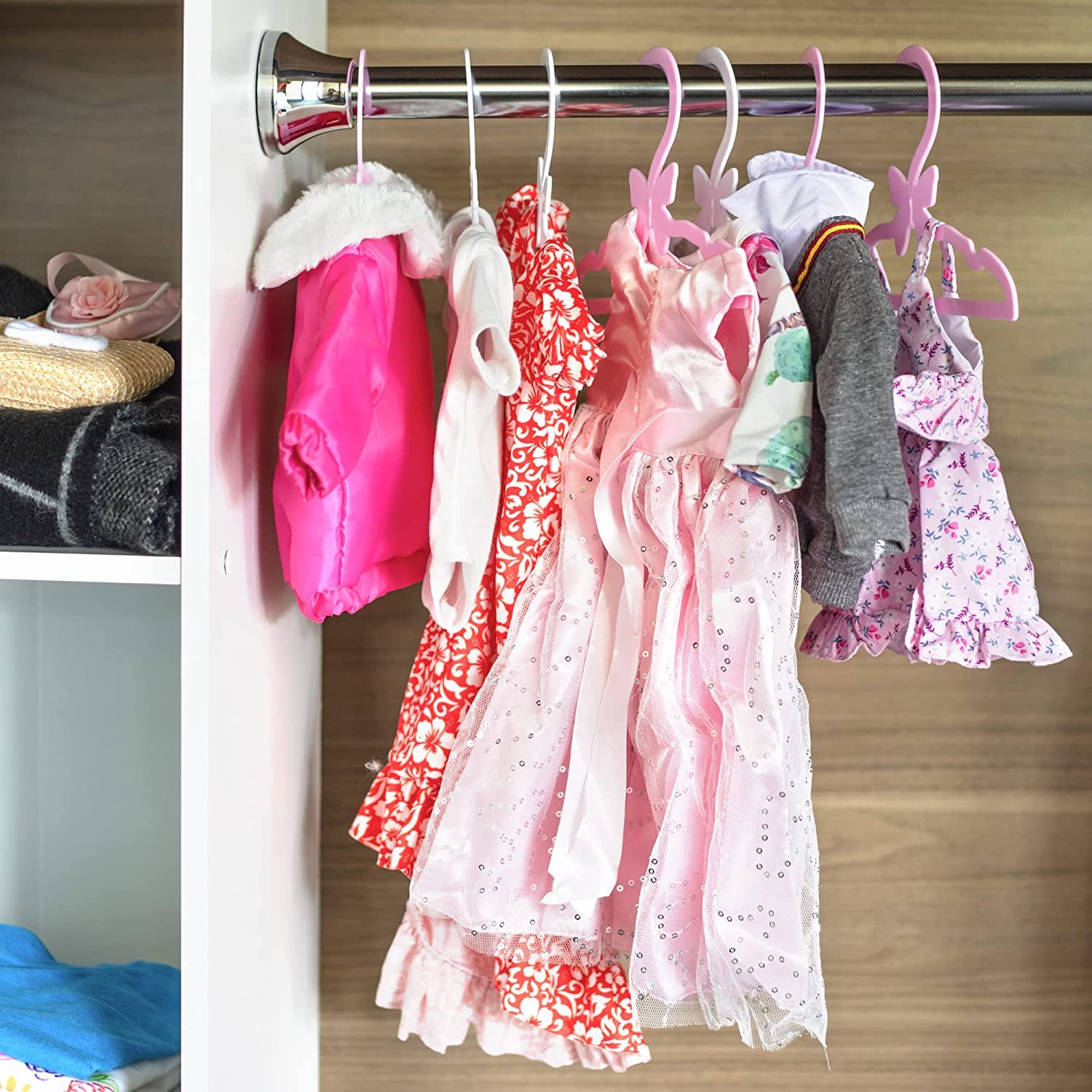 Hanger rack display showing organized doll clothes with Dress Along Dolly.