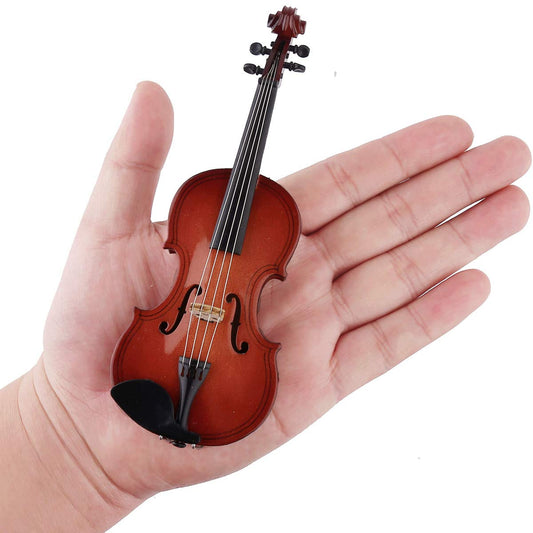 Dselvgvu miniature violin with bow and case shown as elegant desk accent.
