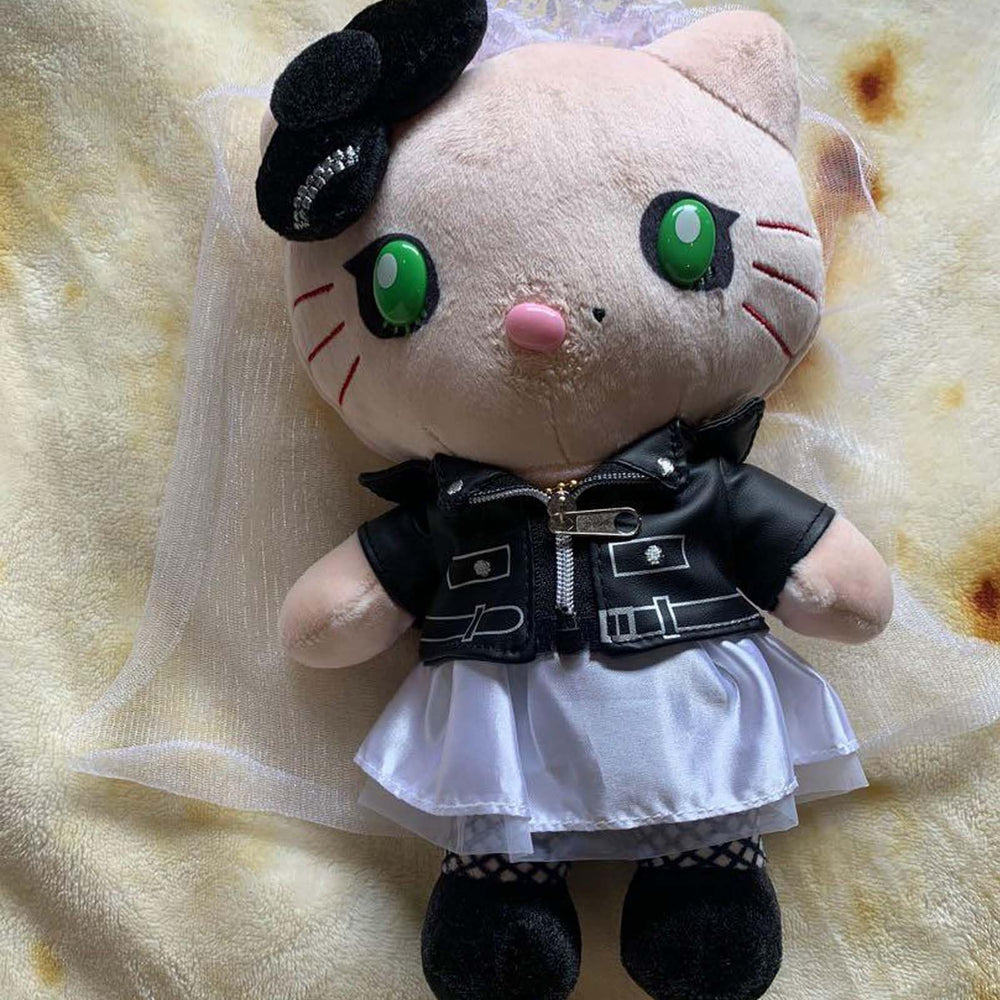 Dupuci 20cm plush size reference beside a book.