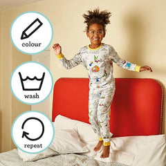 Girl wearing eatsleepdoodle coloring pajamas while coloring fairy tale designs.