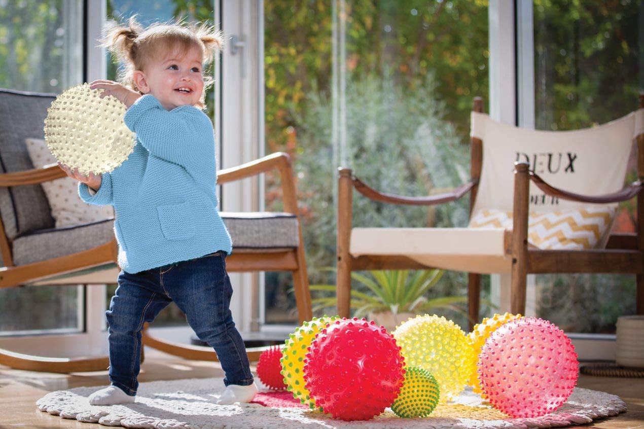 Edushape sensory ball with textured surface and bright colors invites tactile play.